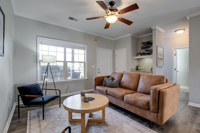 living room with hardwood / wood-style floors, crown molding, built in features, and ceiling fan