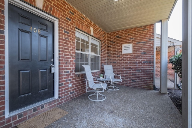 view of exterior entry featuring covered porch