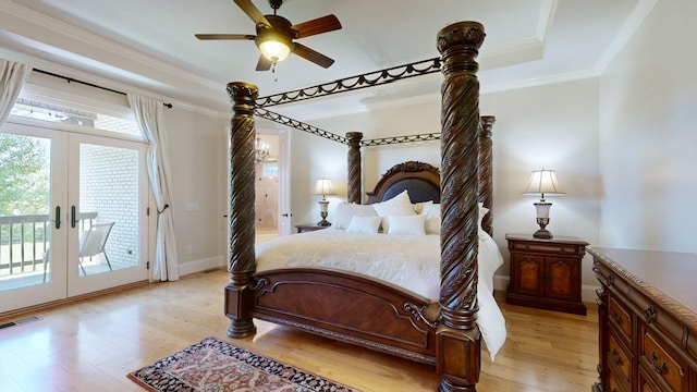 bedroom featuring french doors, light hardwood / wood-style flooring, a raised ceiling, ceiling fan, and access to exterior