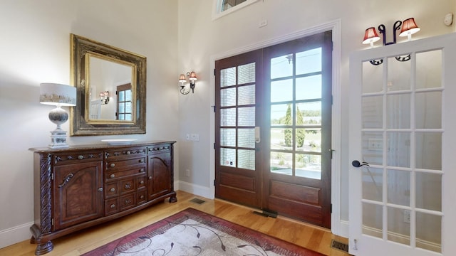 doorway to outside with french doors and light hardwood / wood-style flooring