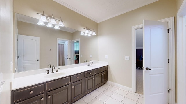 bathroom with ornamental molding, vanity, tile patterned flooring, and a textured ceiling