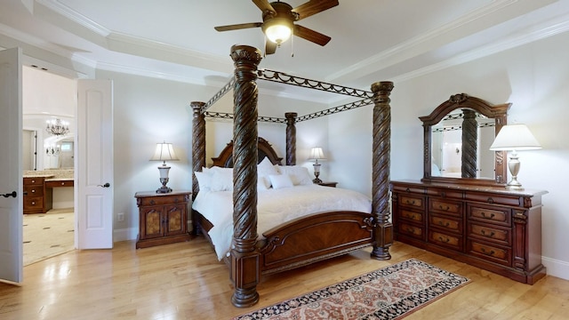 bedroom featuring crown molding, light wood-type flooring, ceiling fan with notable chandelier, and ensuite bath