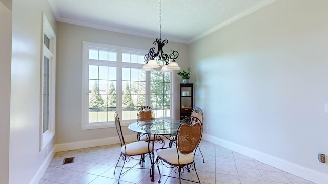 dining room with crown molding, an inviting chandelier, and light tile patterned floors