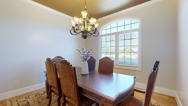 dining room featuring crown molding, wood-type flooring, and a chandelier