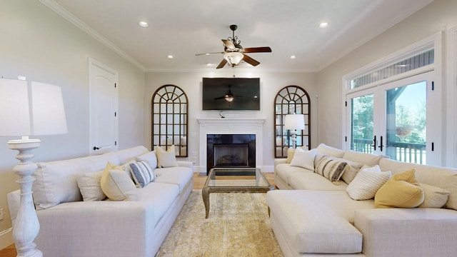 living room with ornamental molding, french doors, and ceiling fan