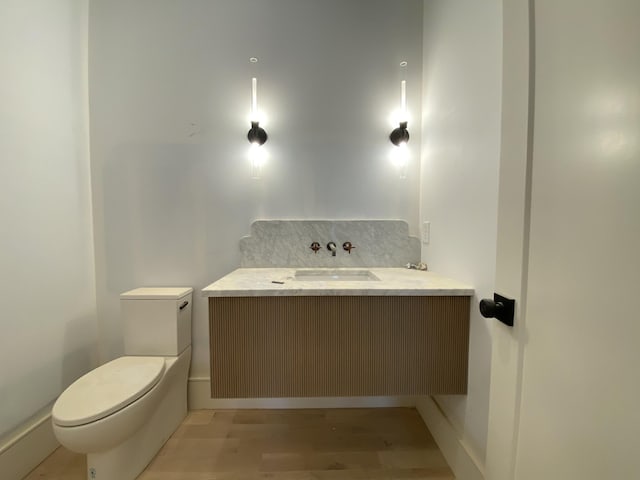 bathroom with vanity, hardwood / wood-style floors, and toilet