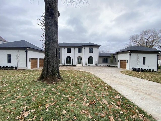 view of front of house featuring a garage and a front lawn