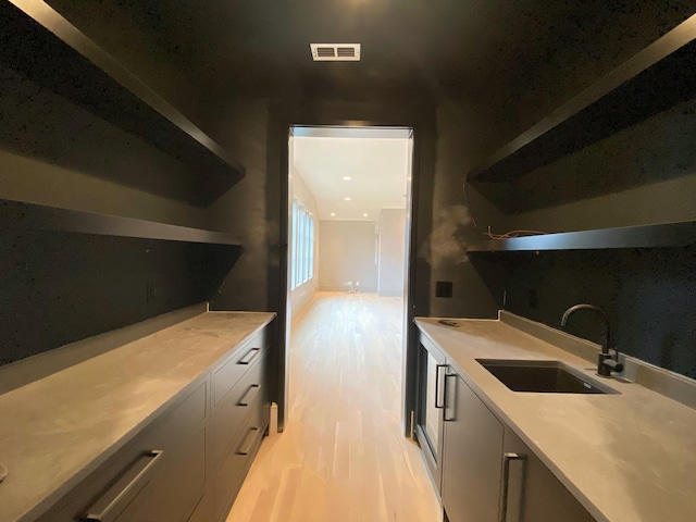 kitchen with sink and light hardwood / wood-style floors