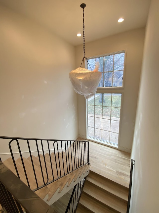 staircase with hardwood / wood-style flooring