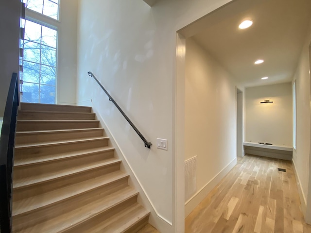 stairs with hardwood / wood-style flooring