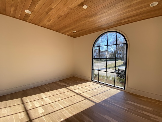 spare room featuring wood ceiling, a wealth of natural light, and wood-type flooring