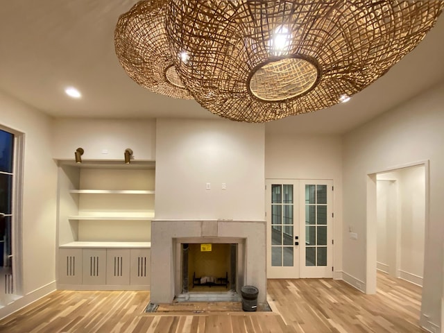 unfurnished living room with french doors and hardwood / wood-style floors