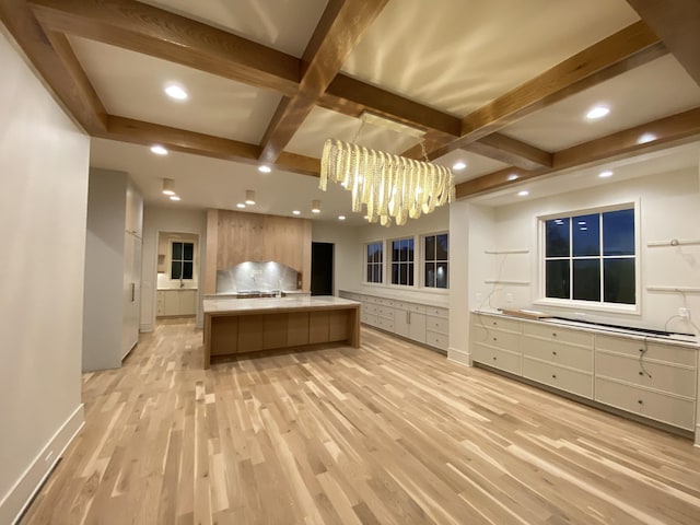 kitchen with a spacious island, an inviting chandelier, hanging light fixtures, and light wood-type flooring