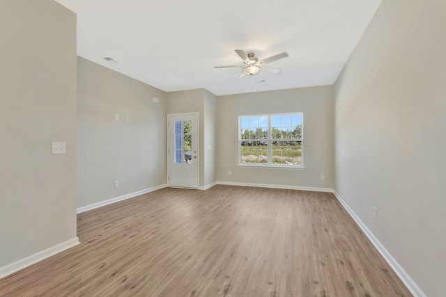 spare room with ceiling fan and light wood-type flooring