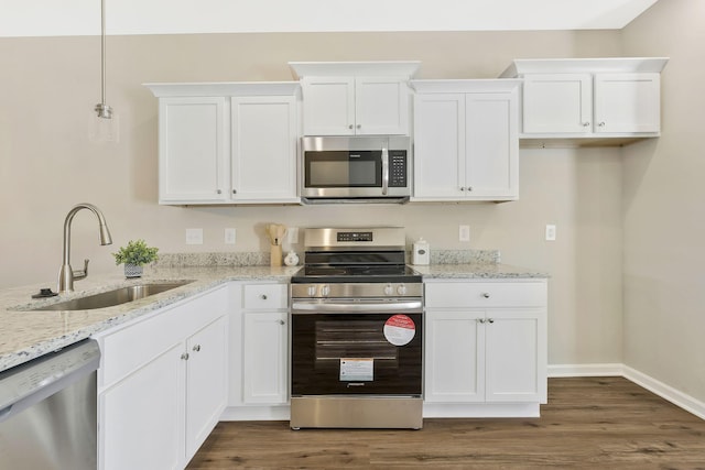 kitchen with stainless steel appliances, white cabinetry, and sink