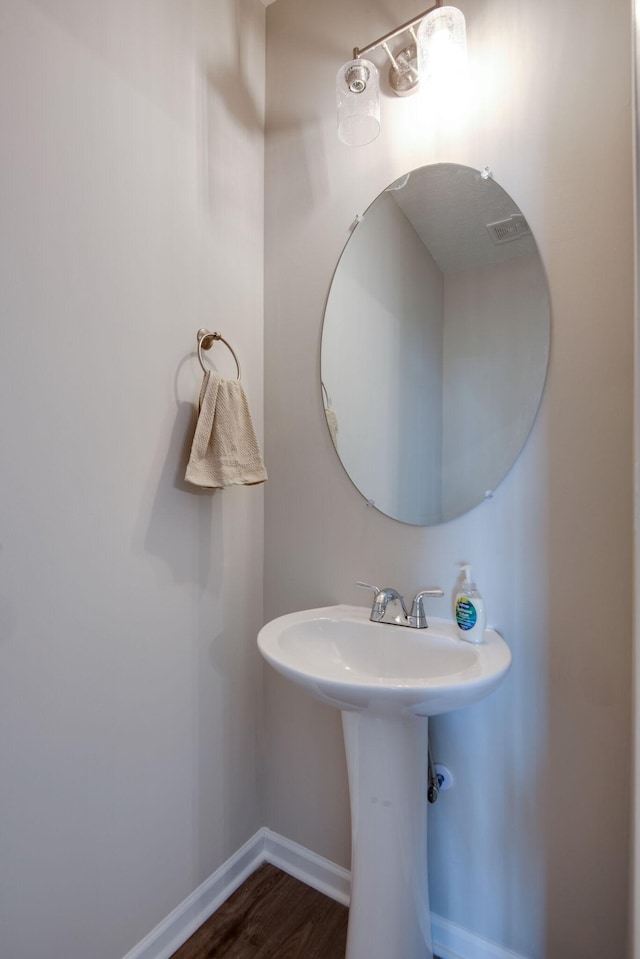 bathroom with hardwood / wood-style floors