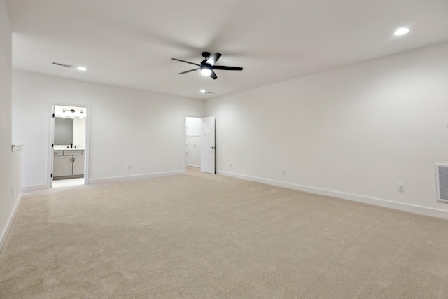 spare room with light carpet and ceiling fan