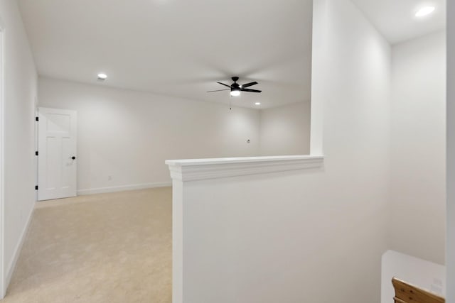 carpeted spare room with ceiling fan