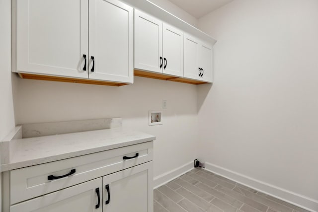 laundry area with hookup for a washing machine and cabinets