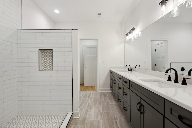 bathroom featuring vanity and a tile shower