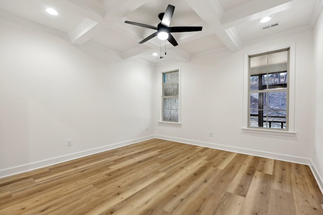 spare room with light wood-type flooring, coffered ceiling, ceiling fan, crown molding, and beam ceiling