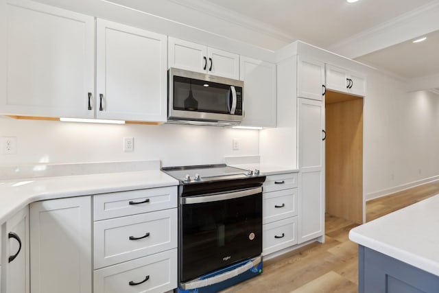 kitchen featuring crown molding, electric range, light hardwood / wood-style flooring, and white cabinets