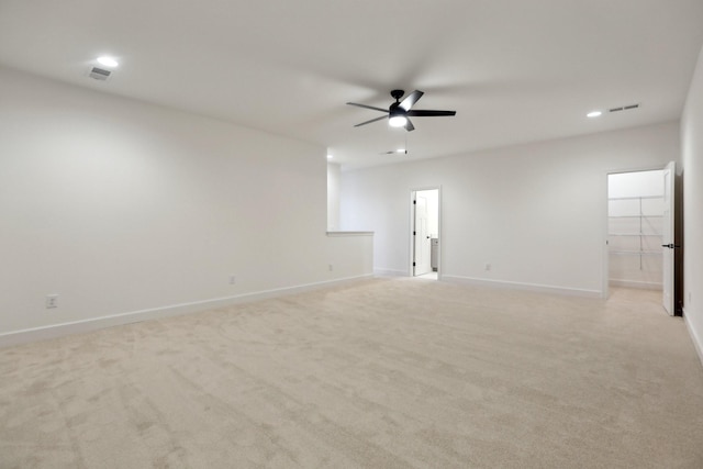 unfurnished room with ceiling fan and light carpet