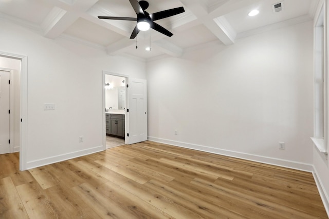 unfurnished bedroom featuring ceiling fan, beam ceiling, ensuite bathroom, coffered ceiling, and light hardwood / wood-style floors