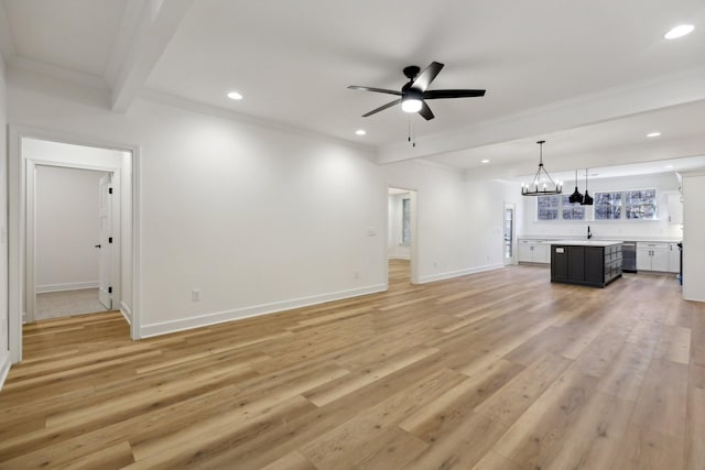 unfurnished living room with ceiling fan with notable chandelier, sink, crown molding, beam ceiling, and light hardwood / wood-style flooring