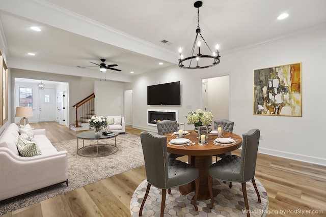 dining room featuring ceiling fan, ornamental molding, and light hardwood / wood-style flooring