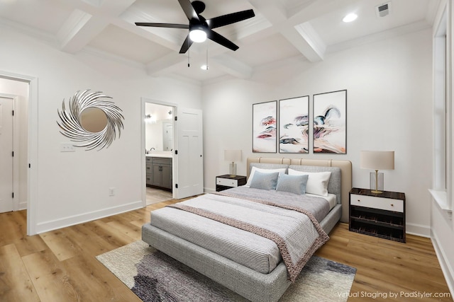 bedroom with beam ceiling, coffered ceiling, connected bathroom, and light wood-type flooring