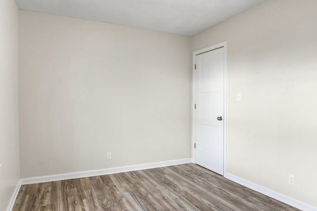 spare room with hardwood / wood-style flooring