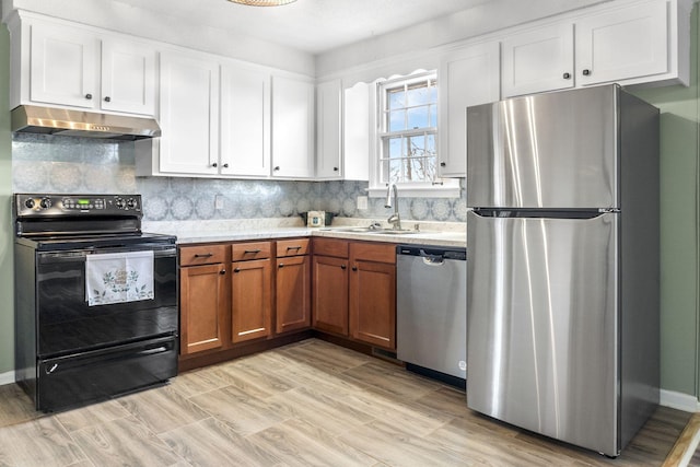 kitchen featuring tasteful backsplash, sink, white cabinets, and appliances with stainless steel finishes