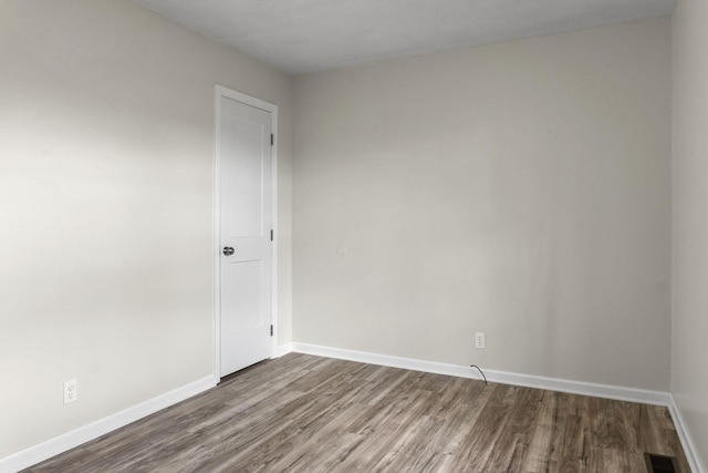 empty room with hardwood / wood-style flooring