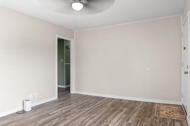 empty room featuring ceiling fan, ornamental molding, and light hardwood / wood-style flooring