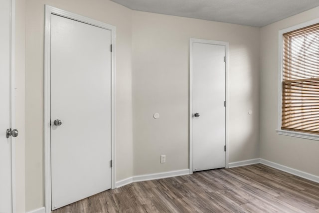 unfurnished bedroom featuring light hardwood / wood-style floors and a closet