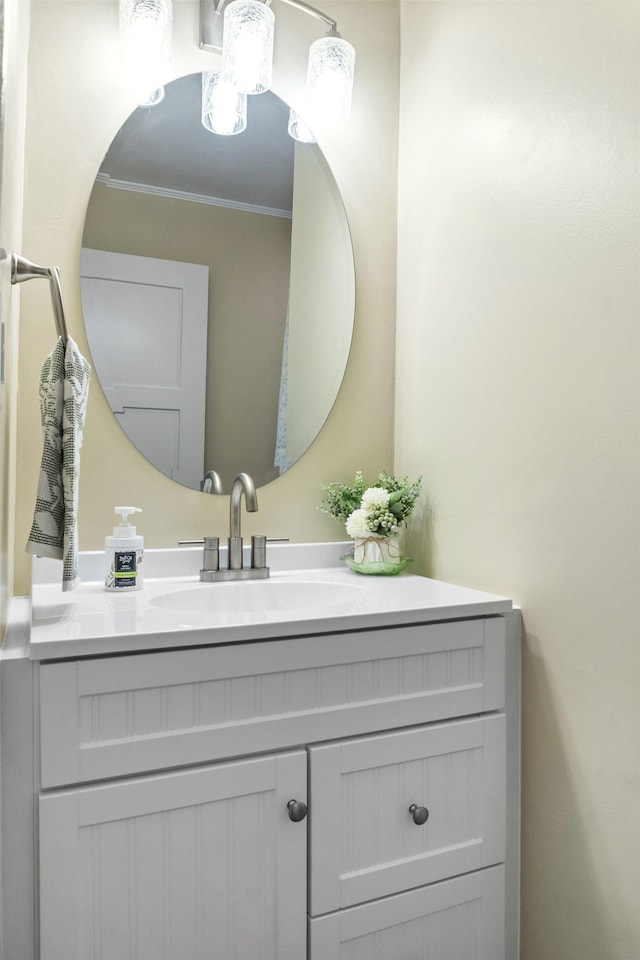 bathroom with vanity and ornamental molding