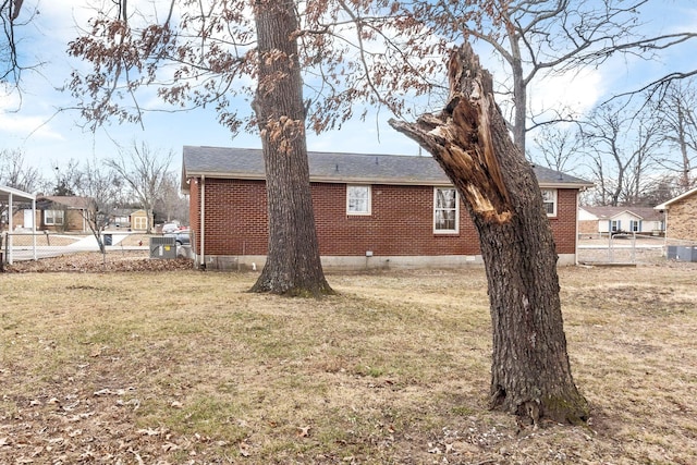 view of side of home featuring a lawn