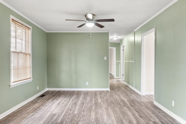 spare room featuring ceiling fan, ornamental molding, and light hardwood / wood-style flooring