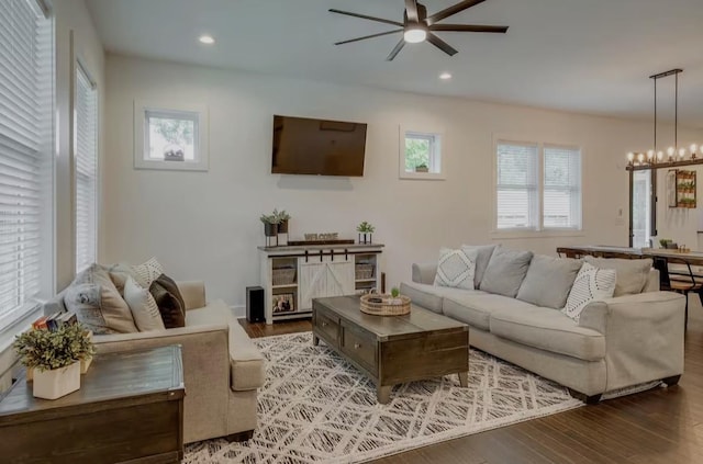 living area featuring ceiling fan with notable chandelier, wood finished floors, and recessed lighting