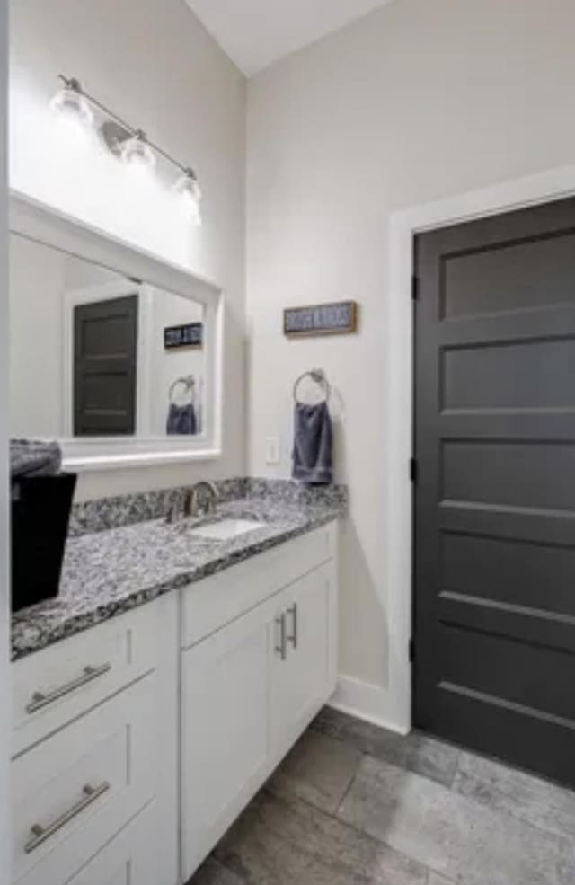 bathroom with baseboards and vanity