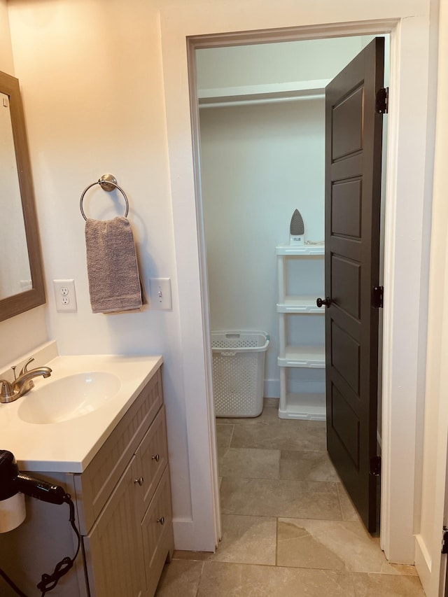 bathroom with vanity and baseboards