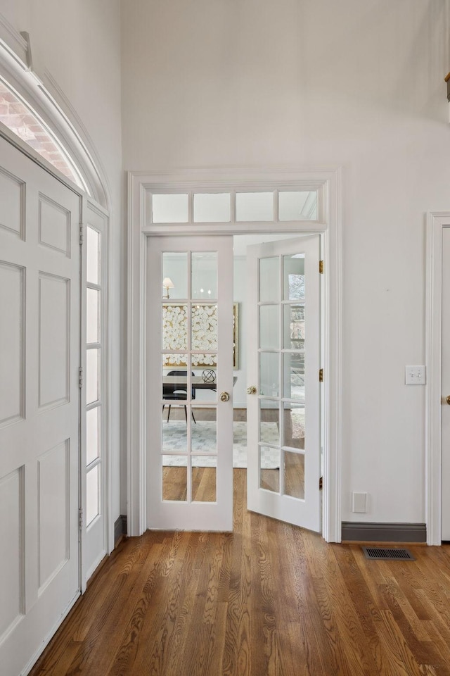 interior space with french doors and dark wood-type flooring