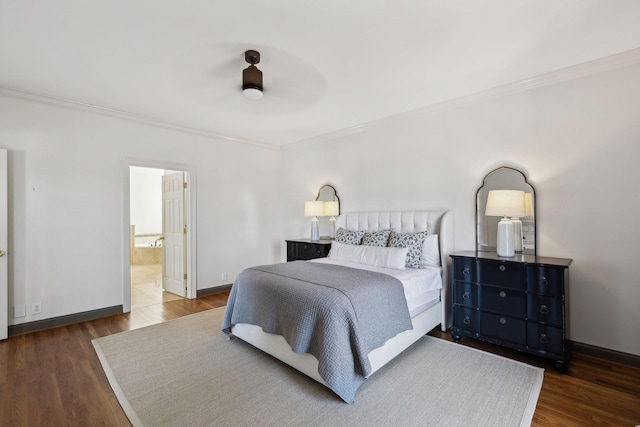 bedroom featuring ornamental molding, dark hardwood / wood-style floors, connected bathroom, and ceiling fan