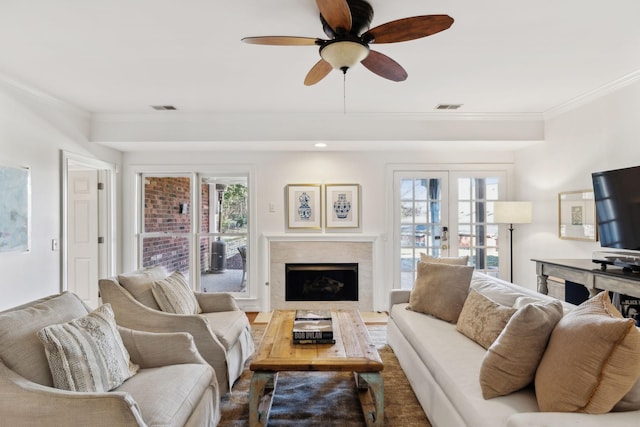 living room with french doors, ceiling fan, and ornamental molding