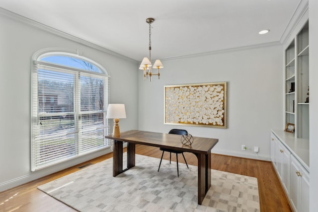 office space with ornamental molding, a chandelier, and light hardwood / wood-style flooring