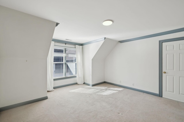 bonus room featuring lofted ceiling and light carpet