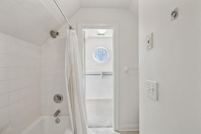 bathroom featuring lofted ceiling and shower / bath combo