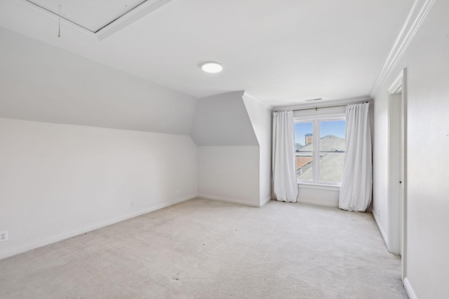 bonus room with light colored carpet and lofted ceiling