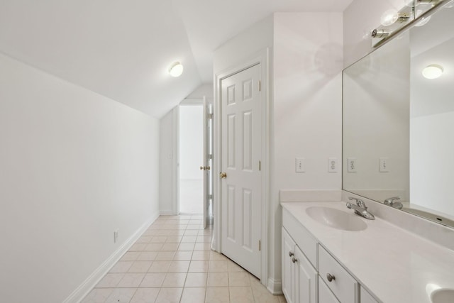 bathroom with vanity, lofted ceiling, and tile patterned floors